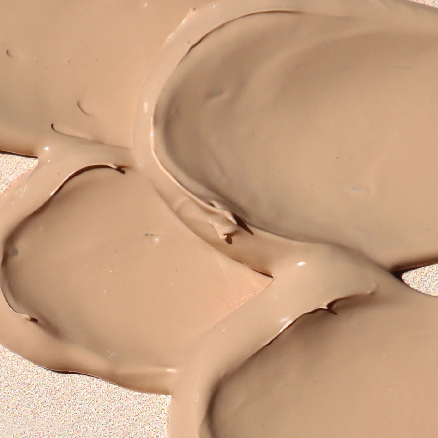Close-up of beige paint swatches on a textured surface