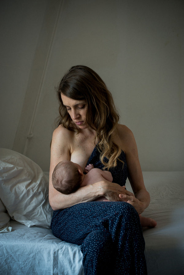 Sarah-Jane Threipland breastfeeding baby. Photography credit: Myscha Oréo