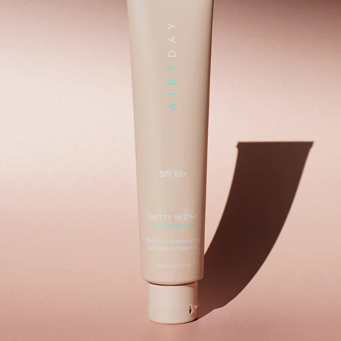 zinc spf Beige tube of skincare product on a pink background